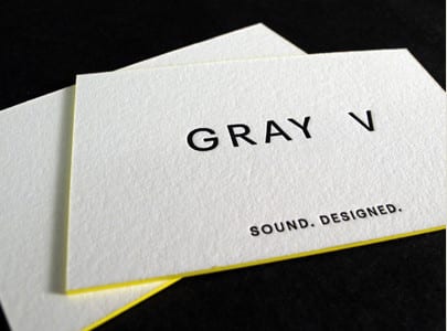 letterpress printed business card black ink on white paper with yellow edge paint