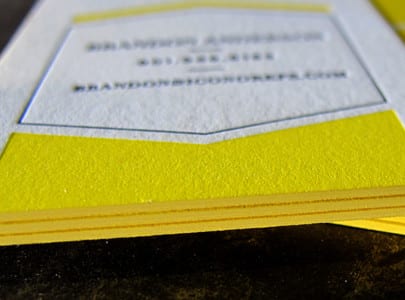 Letterpress printed business card with black and yellow ink, and matching yellow edge painting for Icono