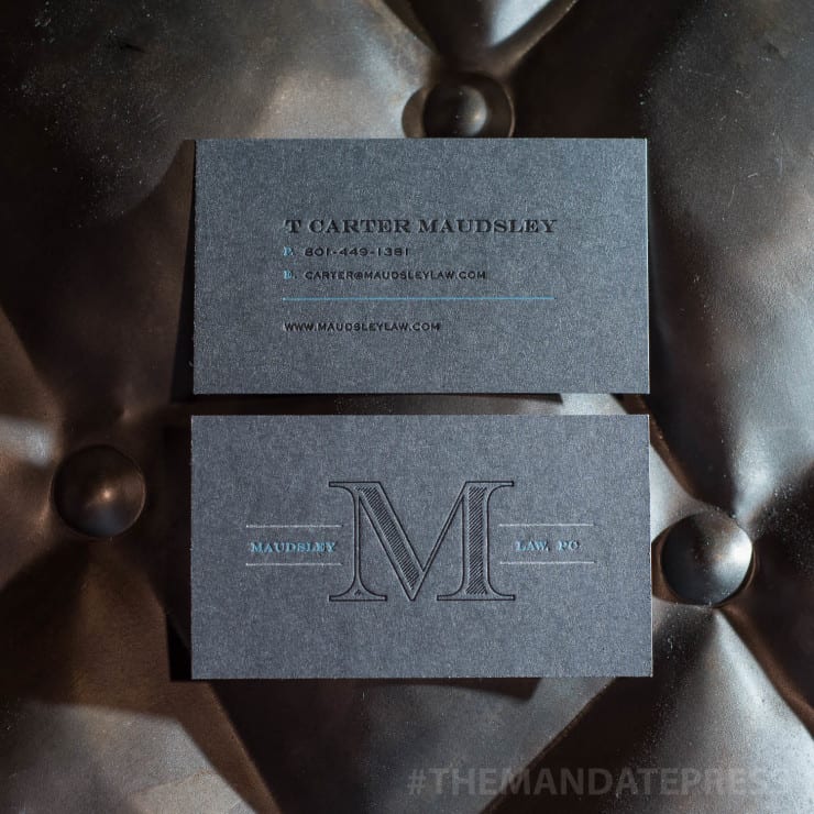 custom business card printed on grey paper with black and blue ink