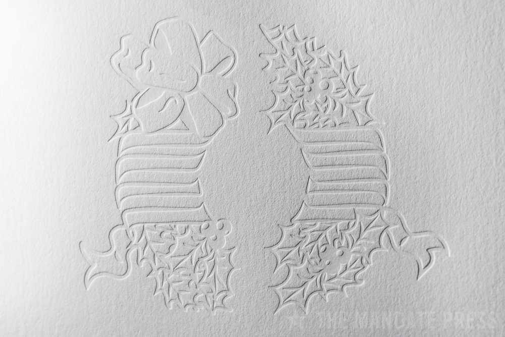 image of inkless blind letterpress printed wreath deboss