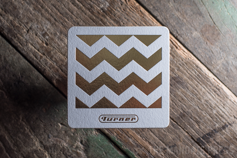 letterpress printed coaster gold foil on white paper