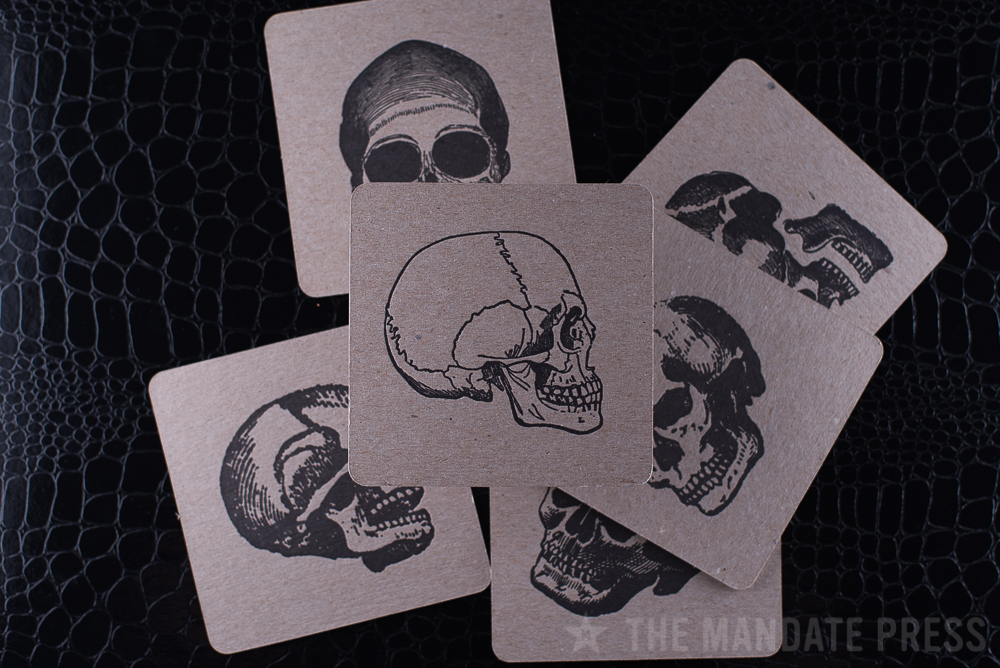 letterpress printed square coater set skulls in black ink on chipboard