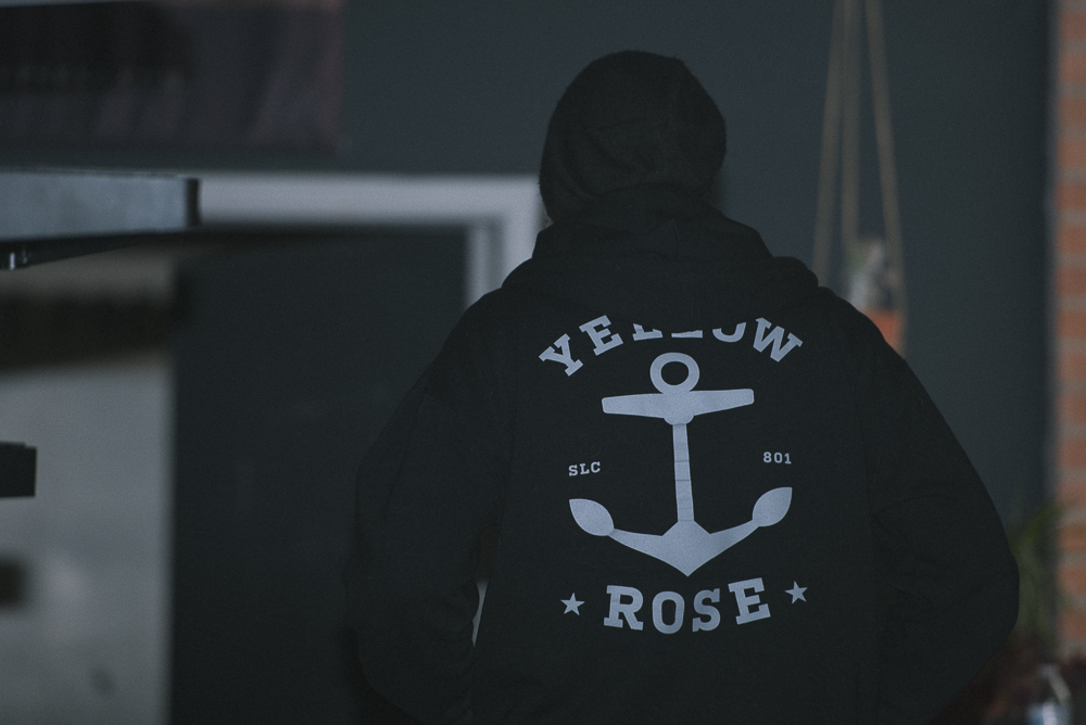 man wearing yellow rose tattoo hooded sweatshirt