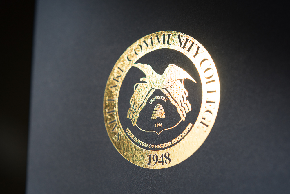 letterpress printed gold foil on blue paper commencement invite for Salt Lake Community College