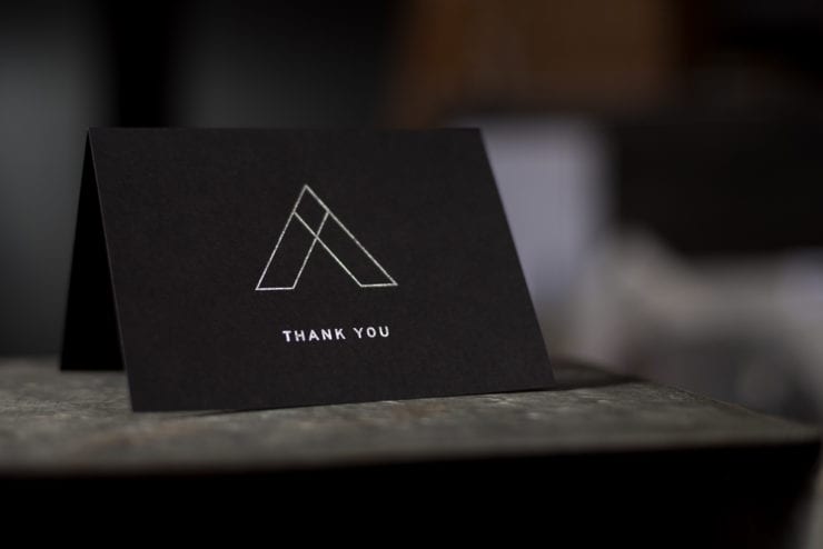 Letterpress thank you card with silver foil on black paper