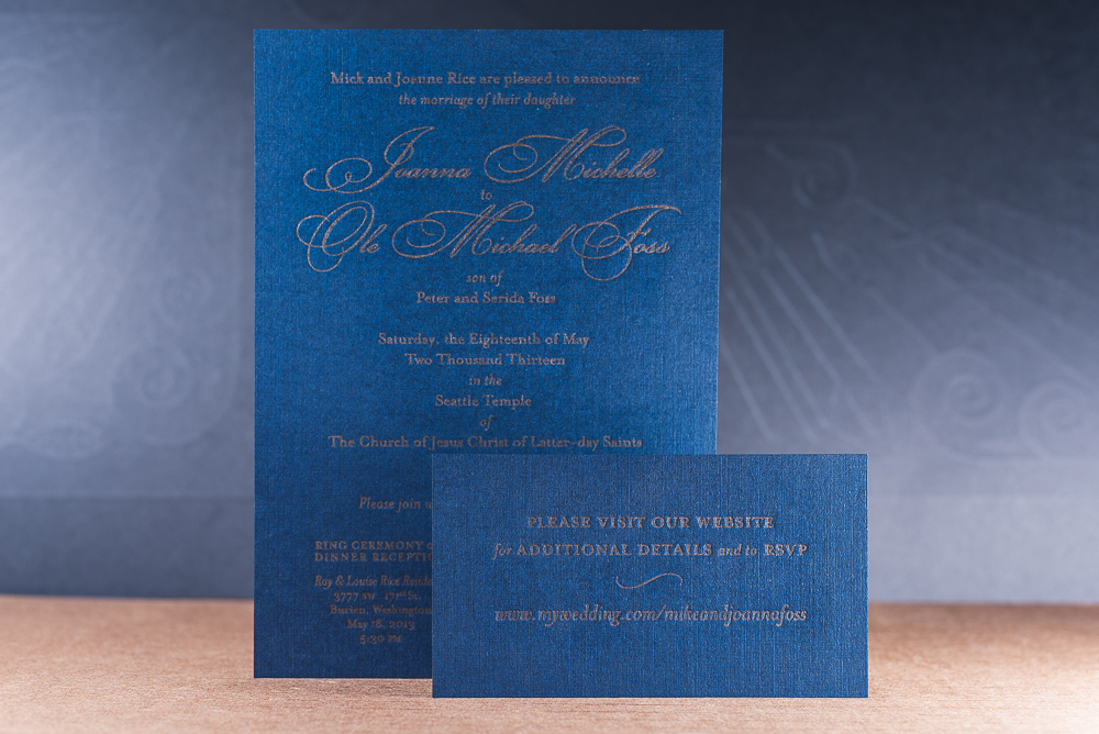 letterpress printed wedding invite gold ink on blue paper with linen texture