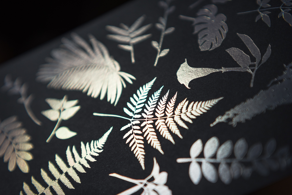 letterpress printed leaves with holographic foil shown at angle without color