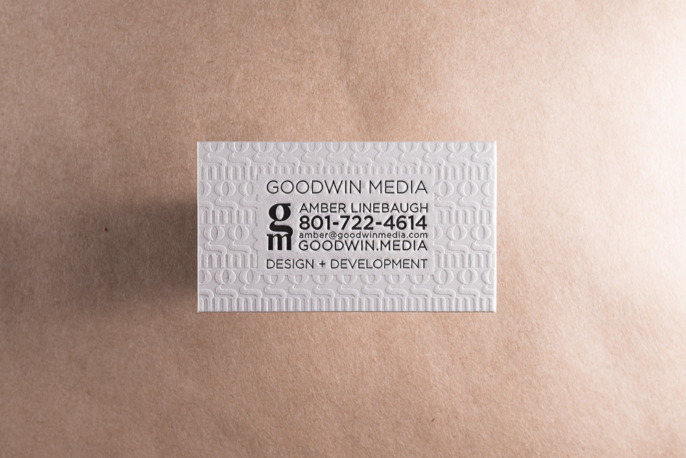 letterpress business card on white paper with blind deboss background